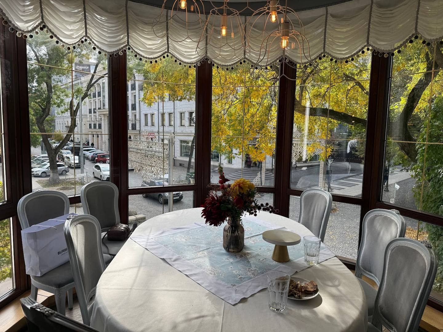 Elegant reception or private dining space with draped ceiling, floor-to-ceiling windows, and street view