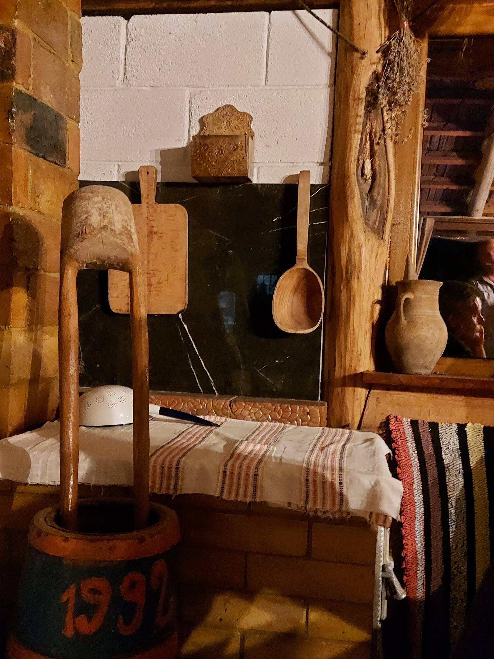 Rustic interior with vintage furnishings, wooden furniture and traditional pottery display