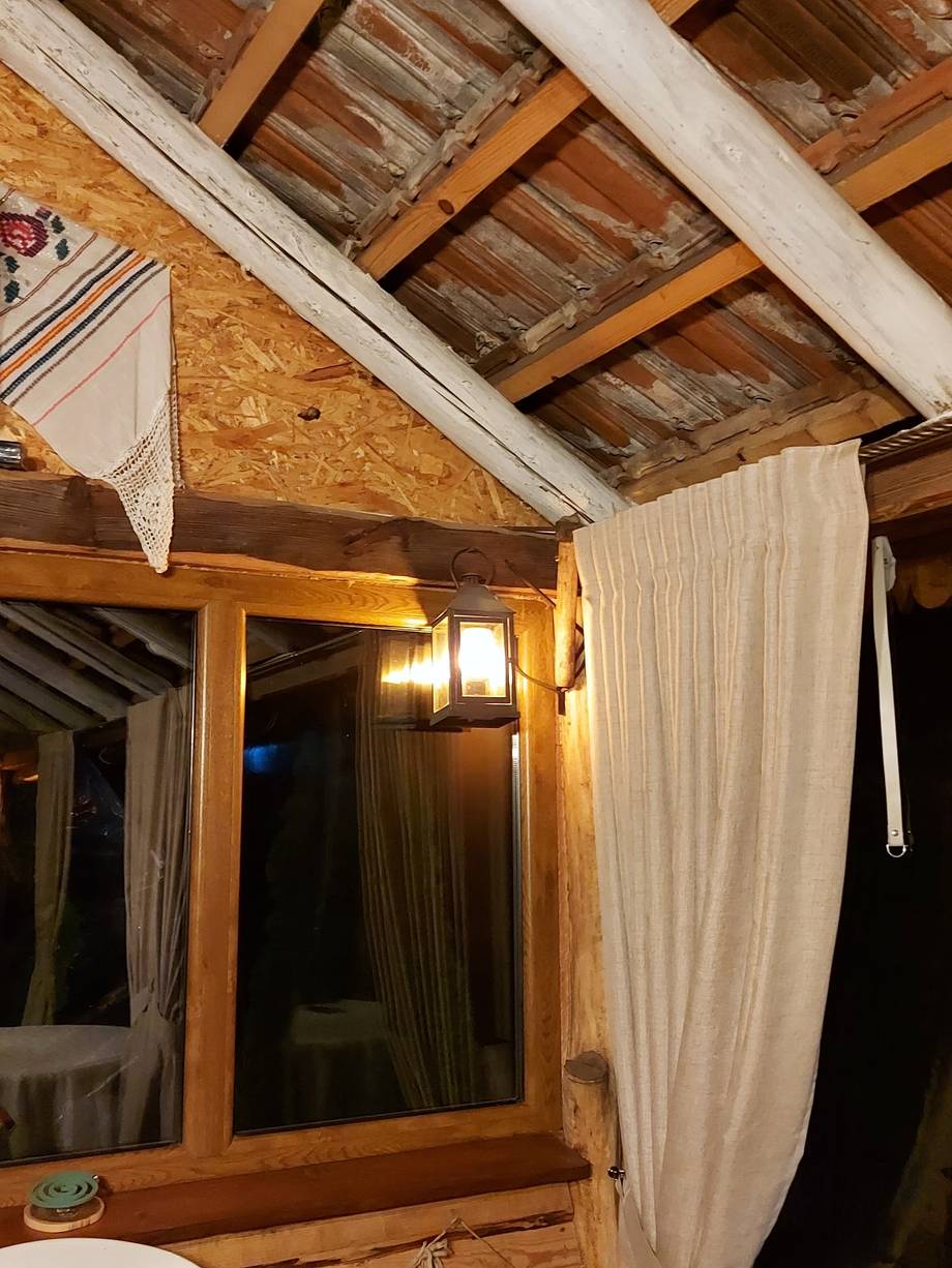 Rustic wooden interior with exposed beams and draped fabric