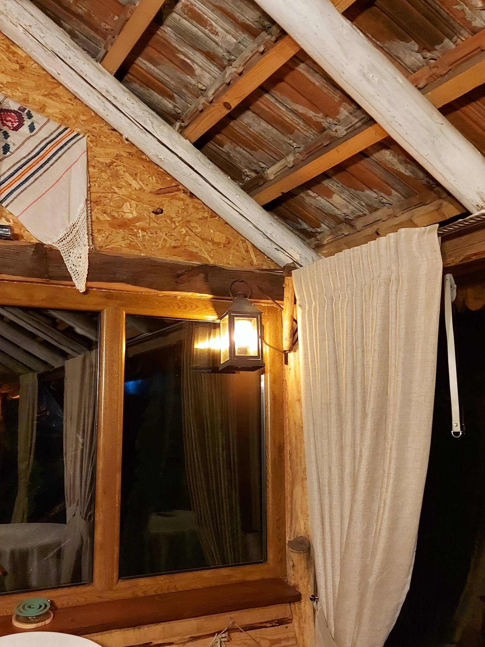 Rustic wooden interior with exposed beams and draped fabric