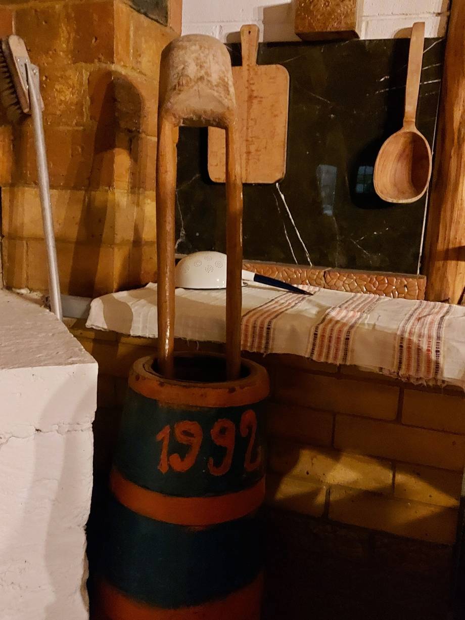 Traditional wooden wine press and tools in historic cellar space