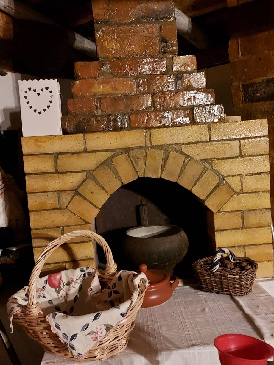 Traditional clay oven with rustic pottery and bread baskets