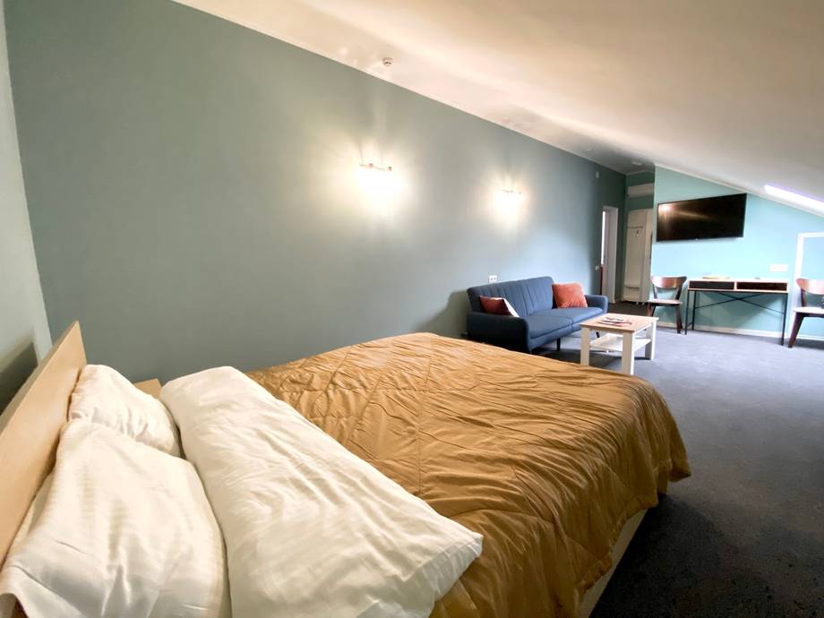 Hotel bedroom with lounge area and modern furnishings