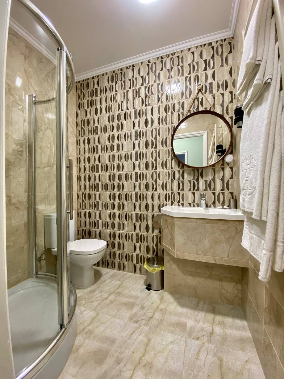 Modern bathroom with geometric tile wall and vanity sink