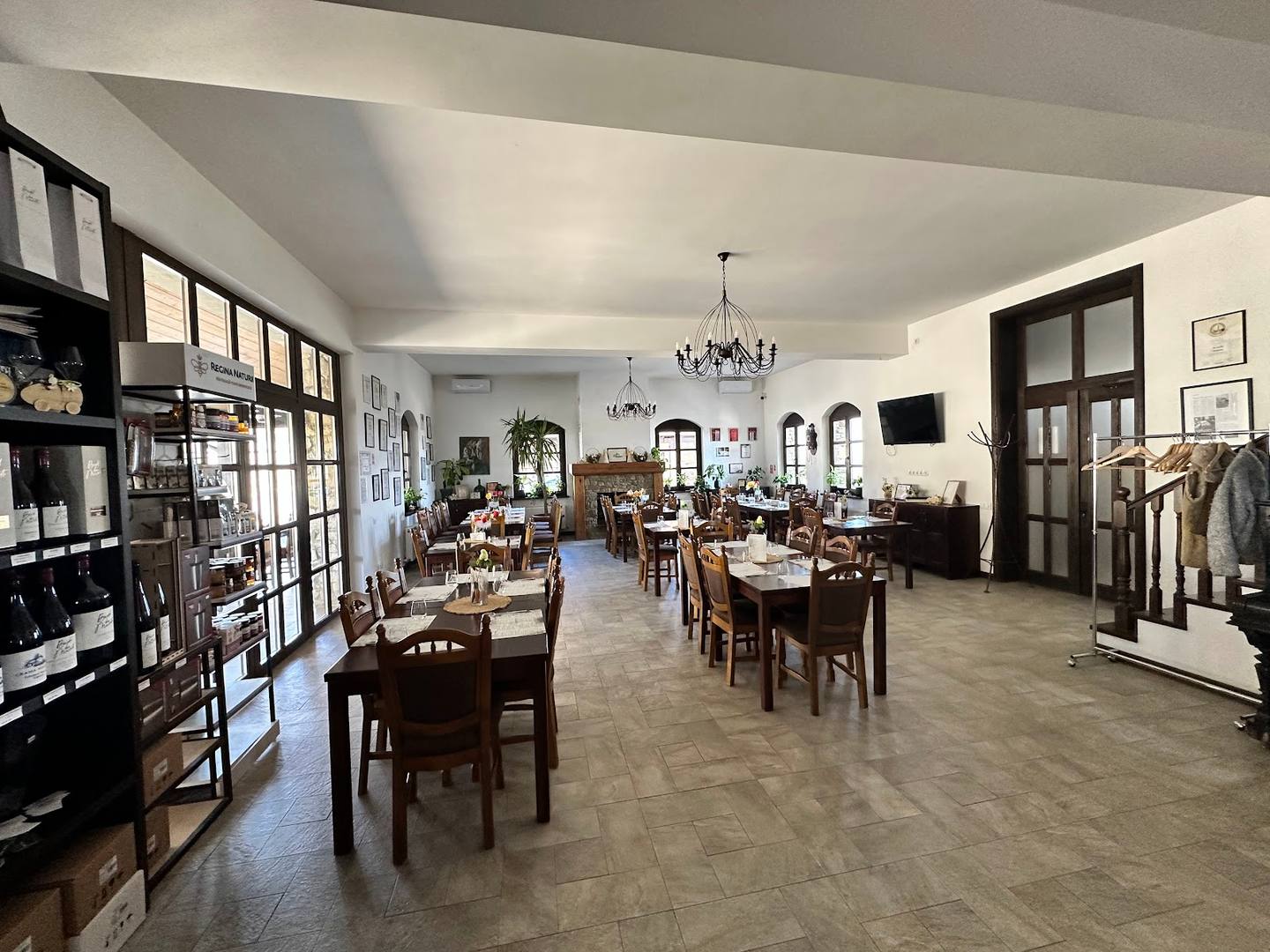 Bright, spacious interior dining area with wooden tables and modern pendant lighting