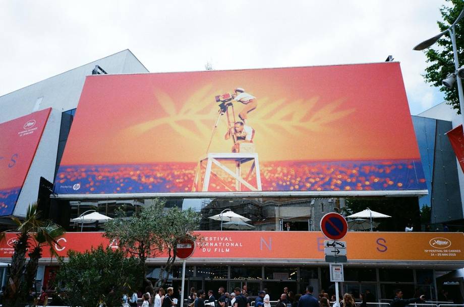 Palais des Festivals exterior with large cinema display and Cannes branding