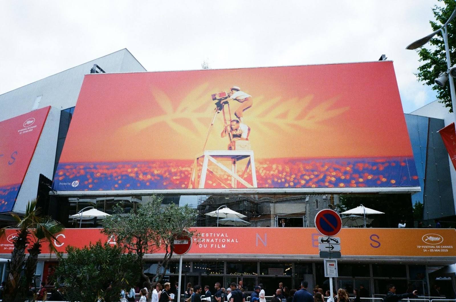 Palais des Festivals exterior with large cinema display and Cannes branding