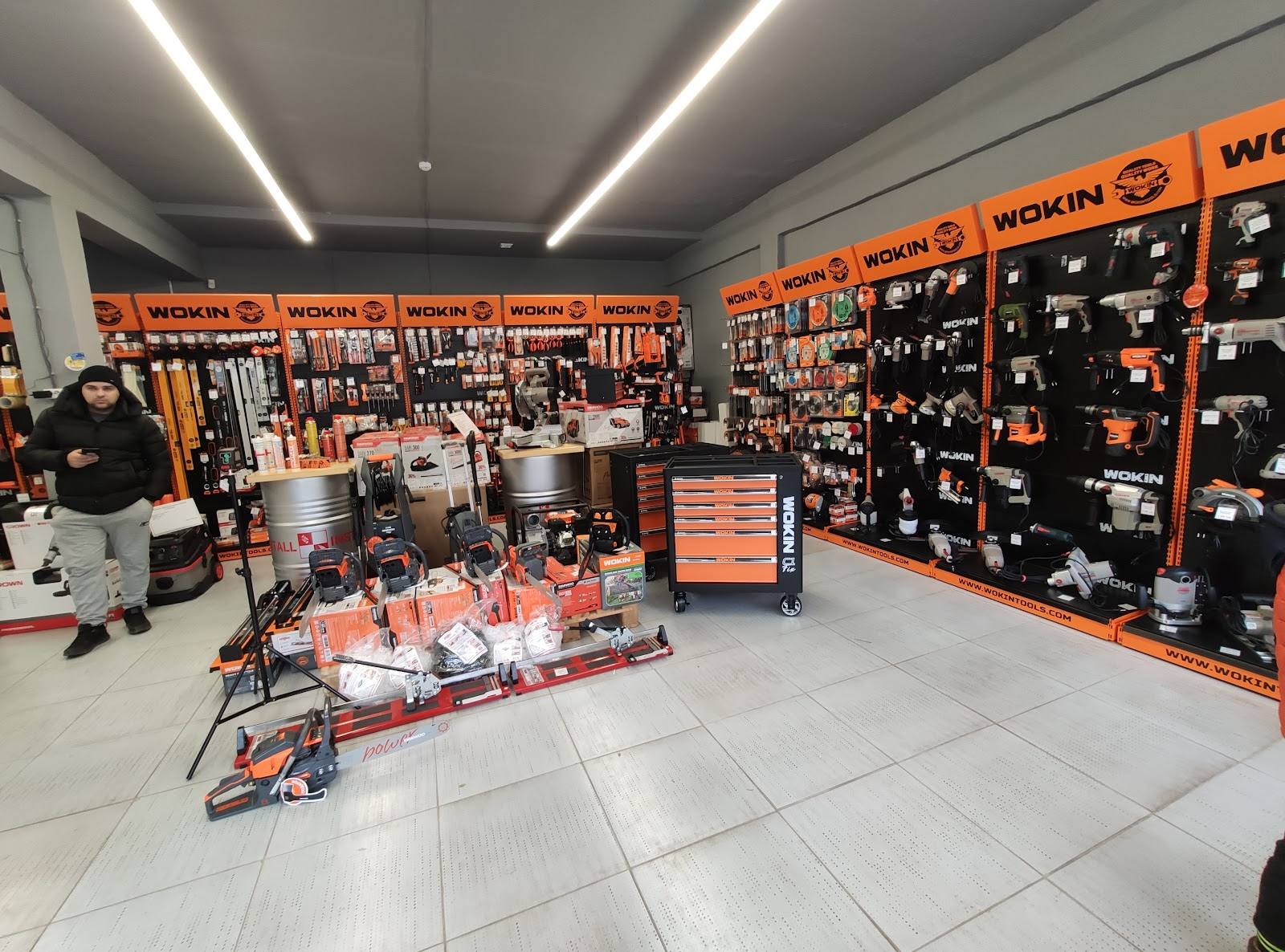Bright, modern tools and equipment retail store with orange and black branded walls