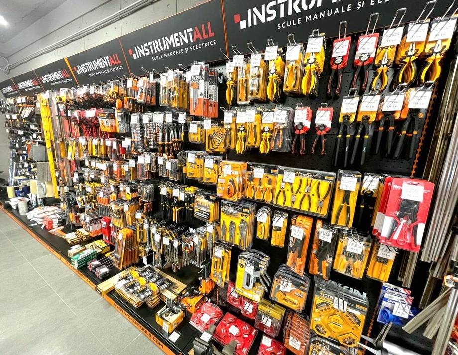 Tool and instrument retail wall display with organized yellow and black packaging