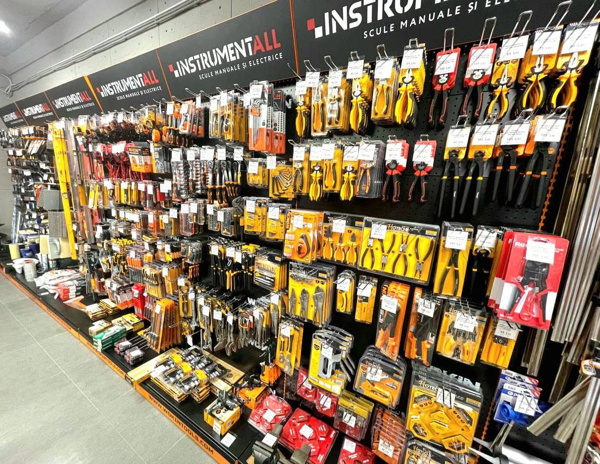 Tool and instrument retail wall display with organized yellow and black packaging