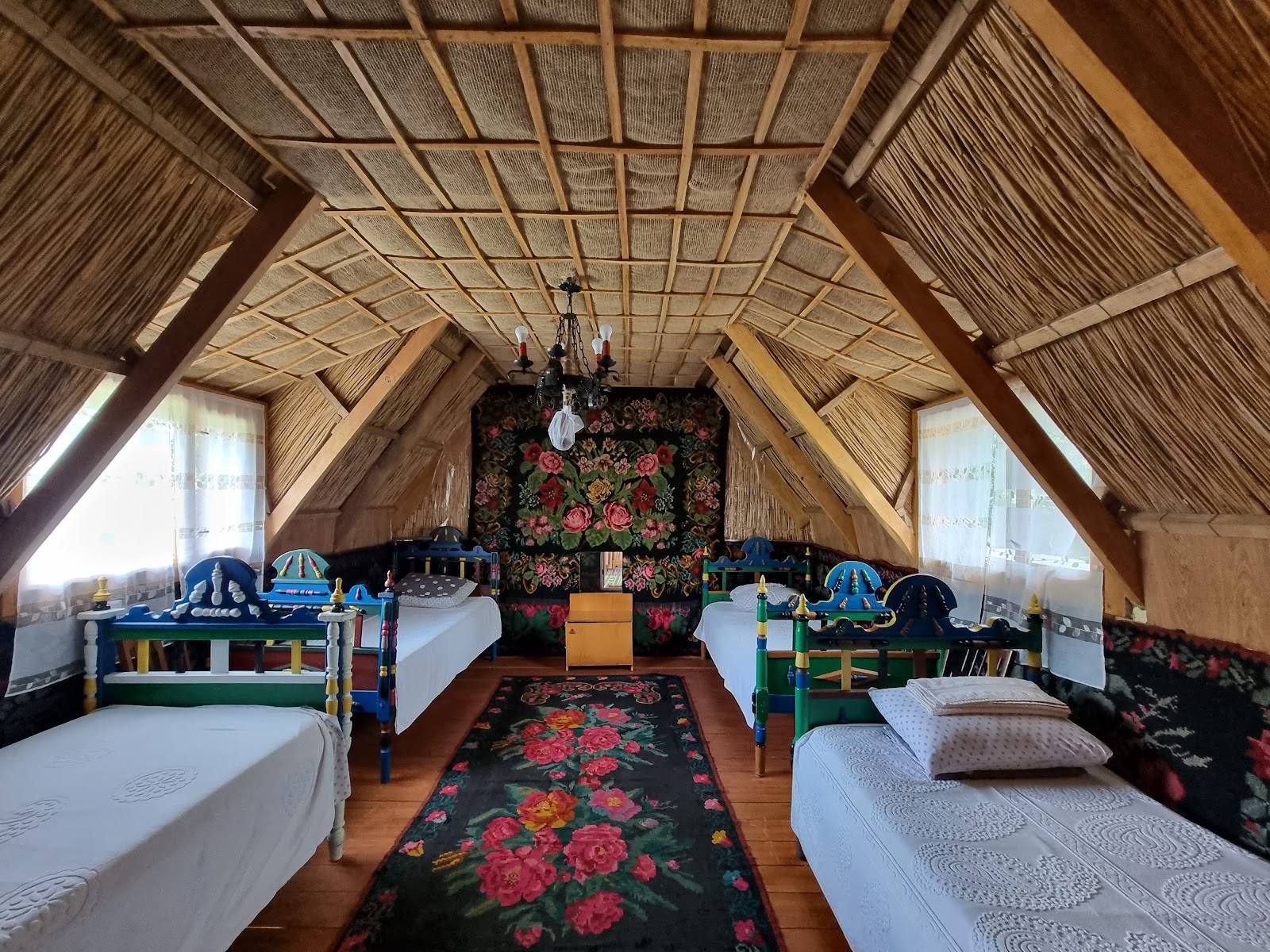 Traditional Moldovan wooden guesthouse interior with twin beds and exposed beam ceiling