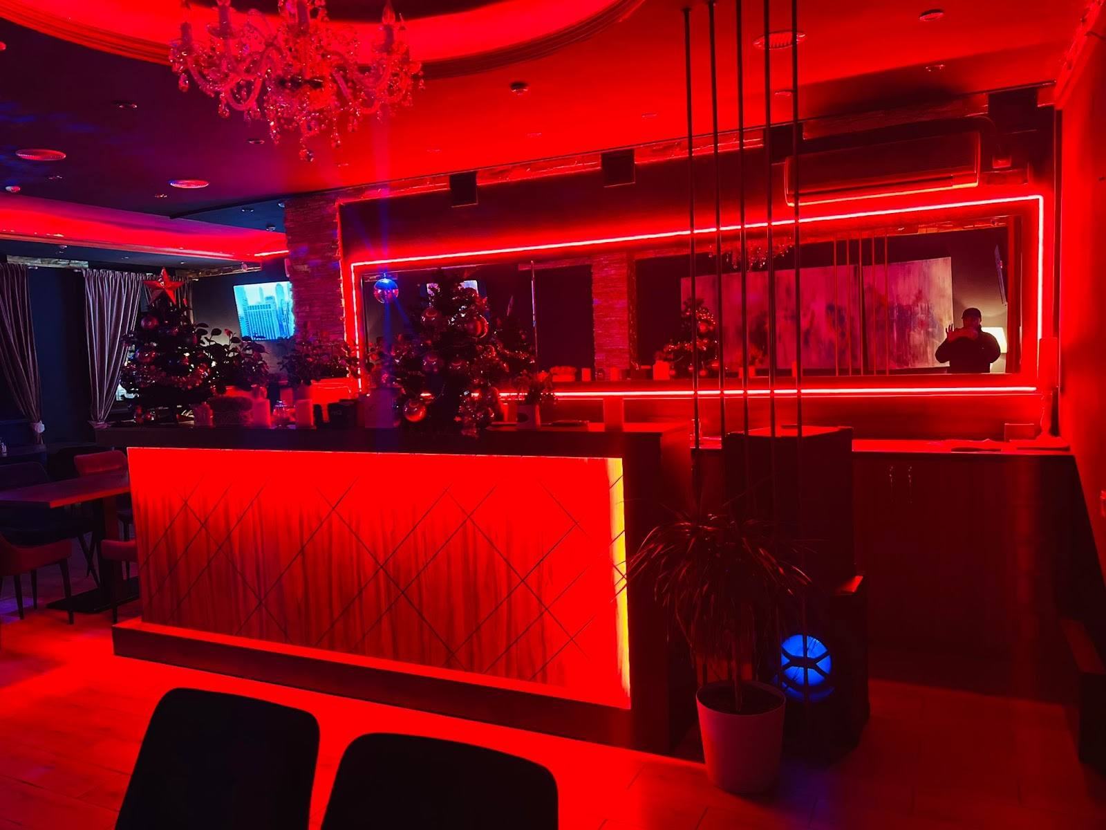 Modern nightclub bar with red neon lighting and geometric design