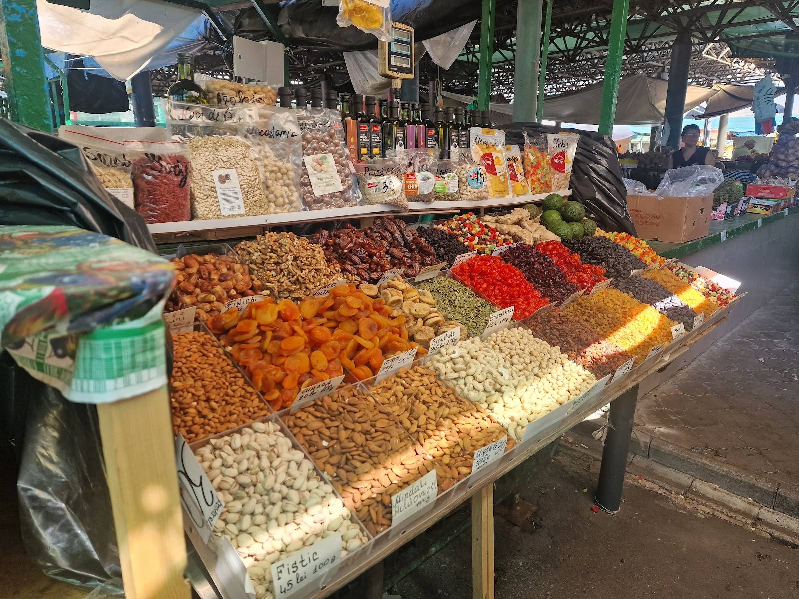 Colorful dried goods and spices display at an outdoor market stand