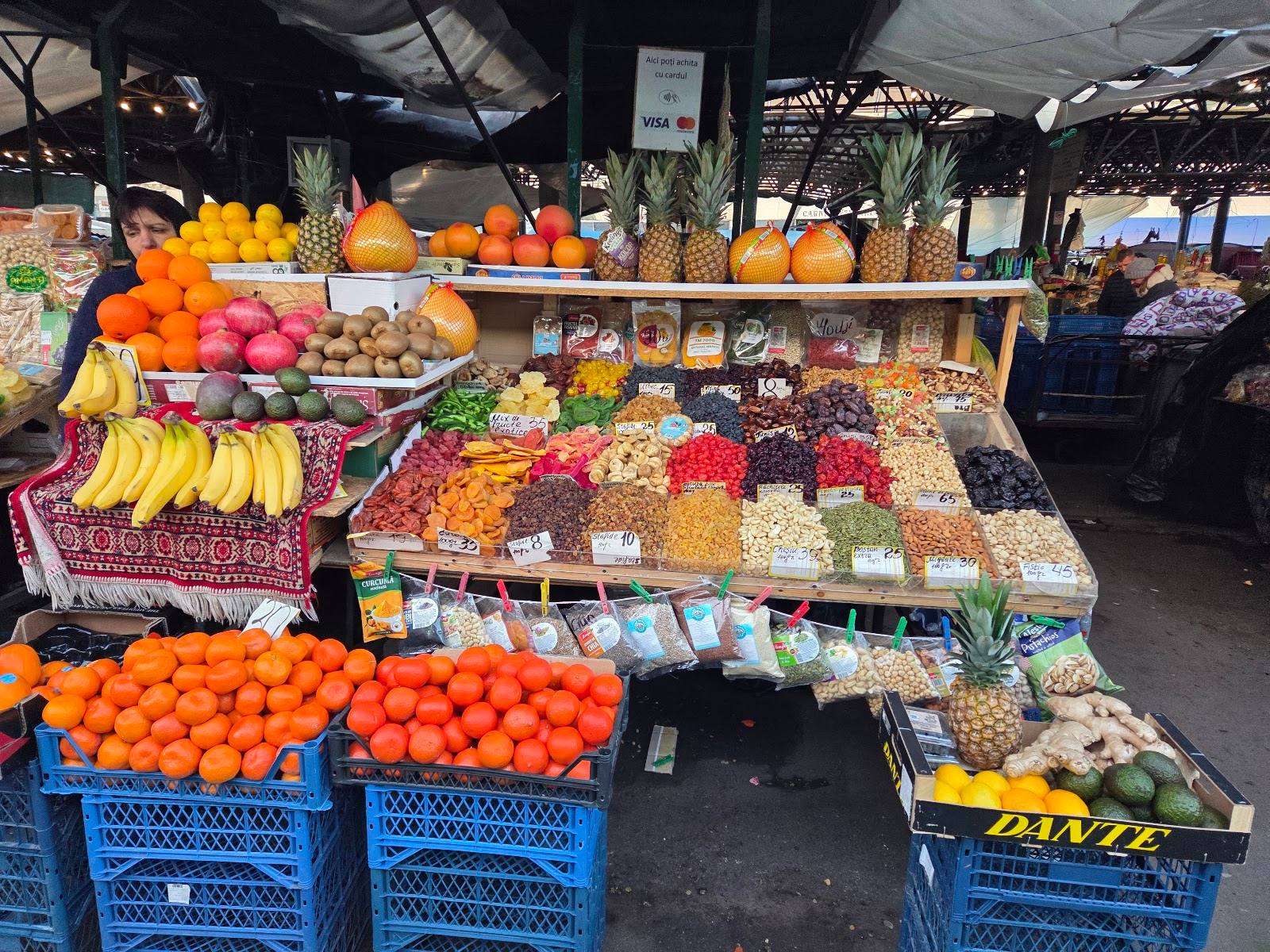 Fresh produce display at Moldova farmers market with tropical fruits and vegetables