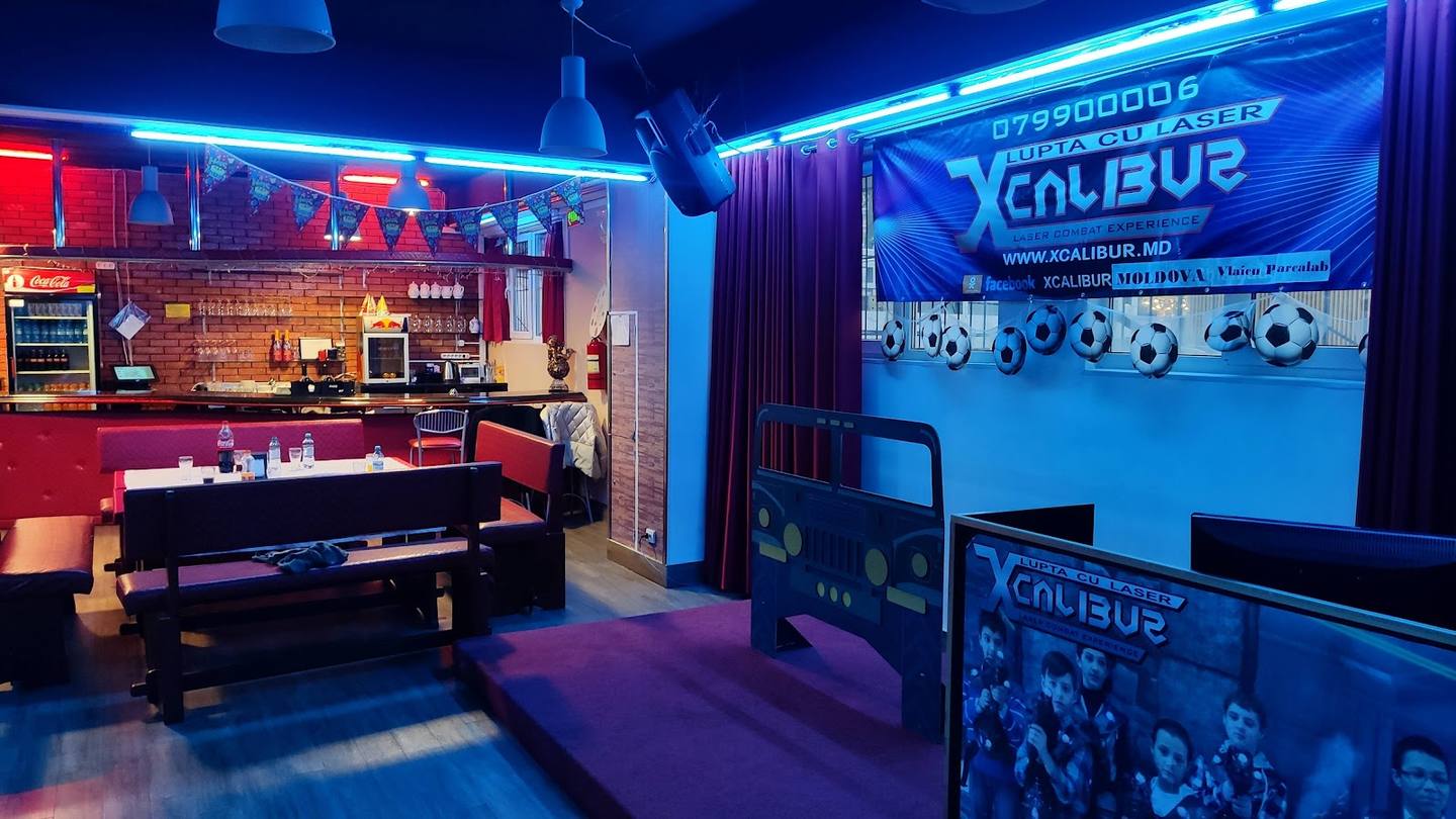 Professional gaming and music studio with neon-lit mixing station, DJ booth, and production equipment