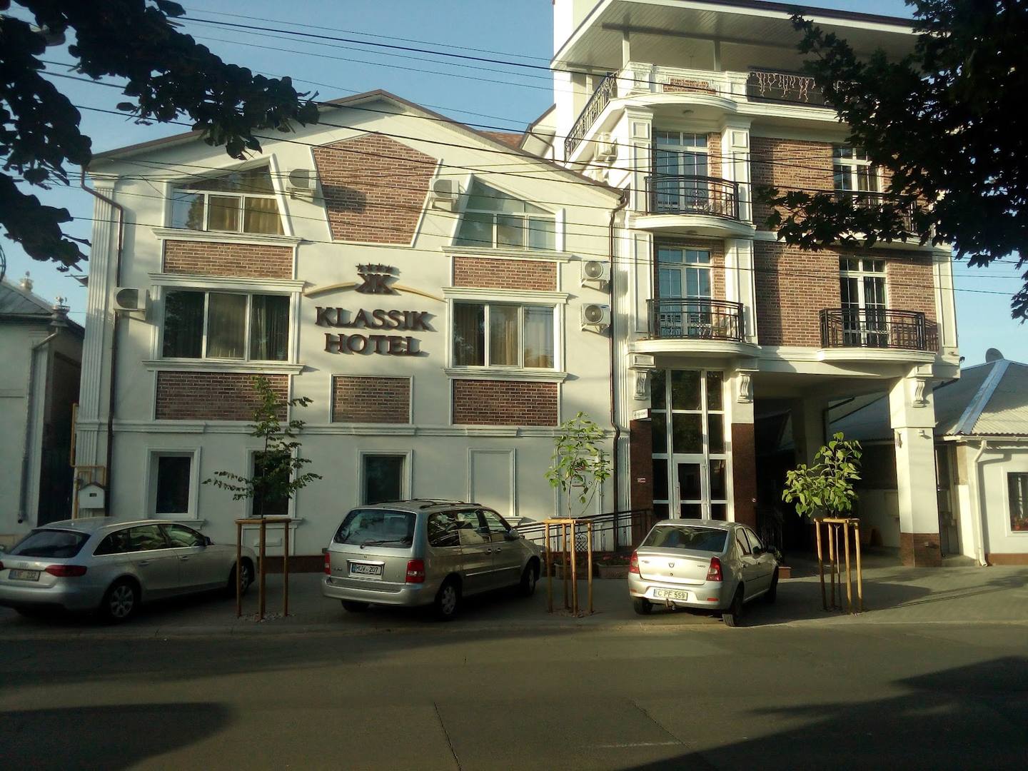 Multi-story building with brick and white facade, street-level storefront entrance visible