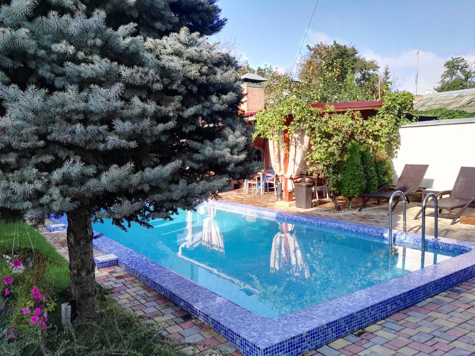 Resort pool with fountain, lounge chairs, and landscaped gardens at daytime
