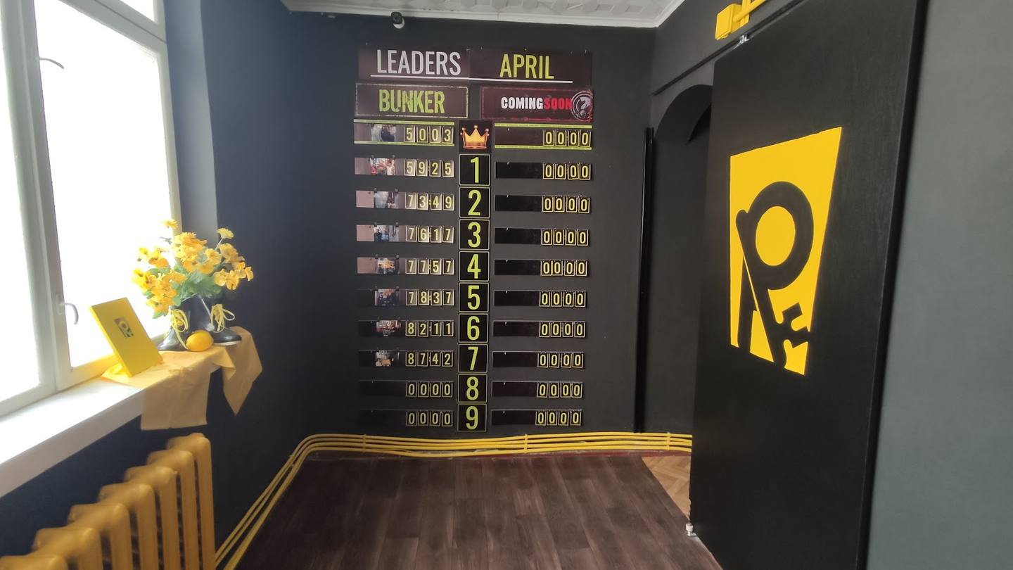 Gaming lounge interior with leaderboard and yellow branded decor