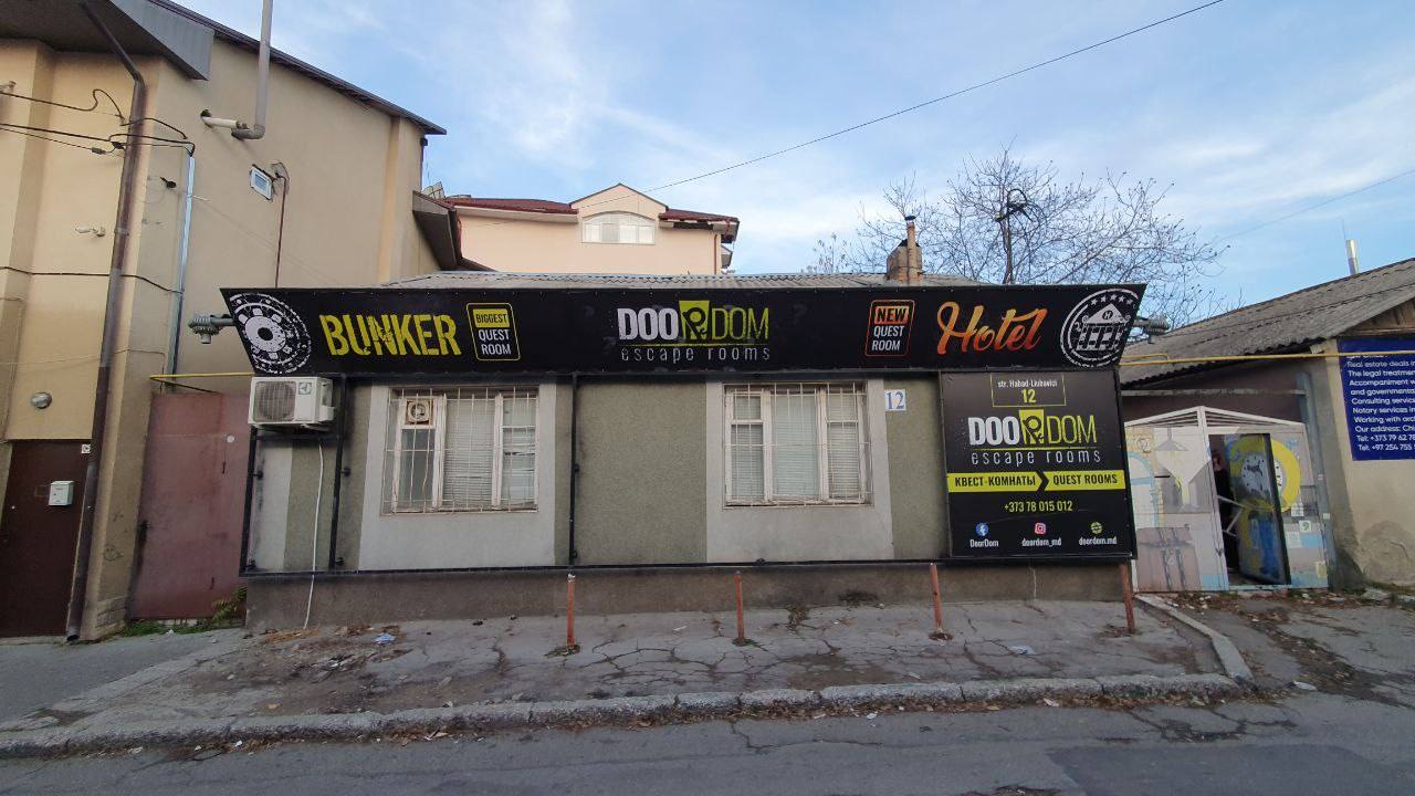 Street-level view of storefront with signage and awning