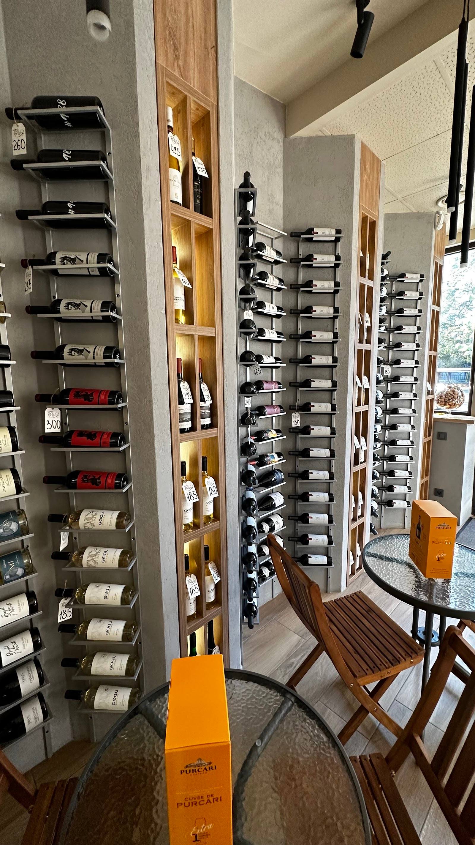 Wine tasting room with floor-to-ceiling bottle storage and wooden display shelving