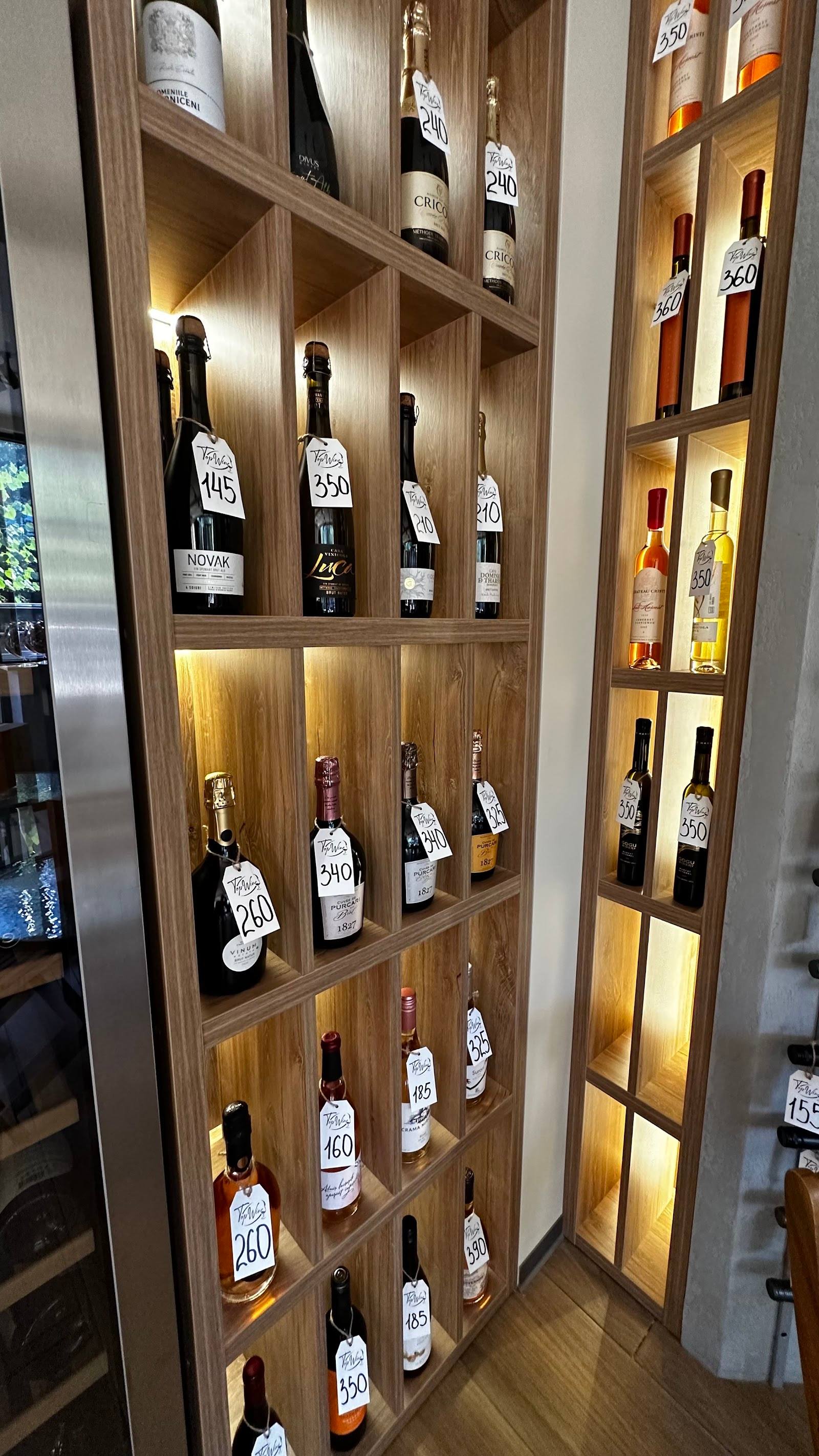 Illuminated wooden wine display cabinet with curated bottle collection and warm LED lighting