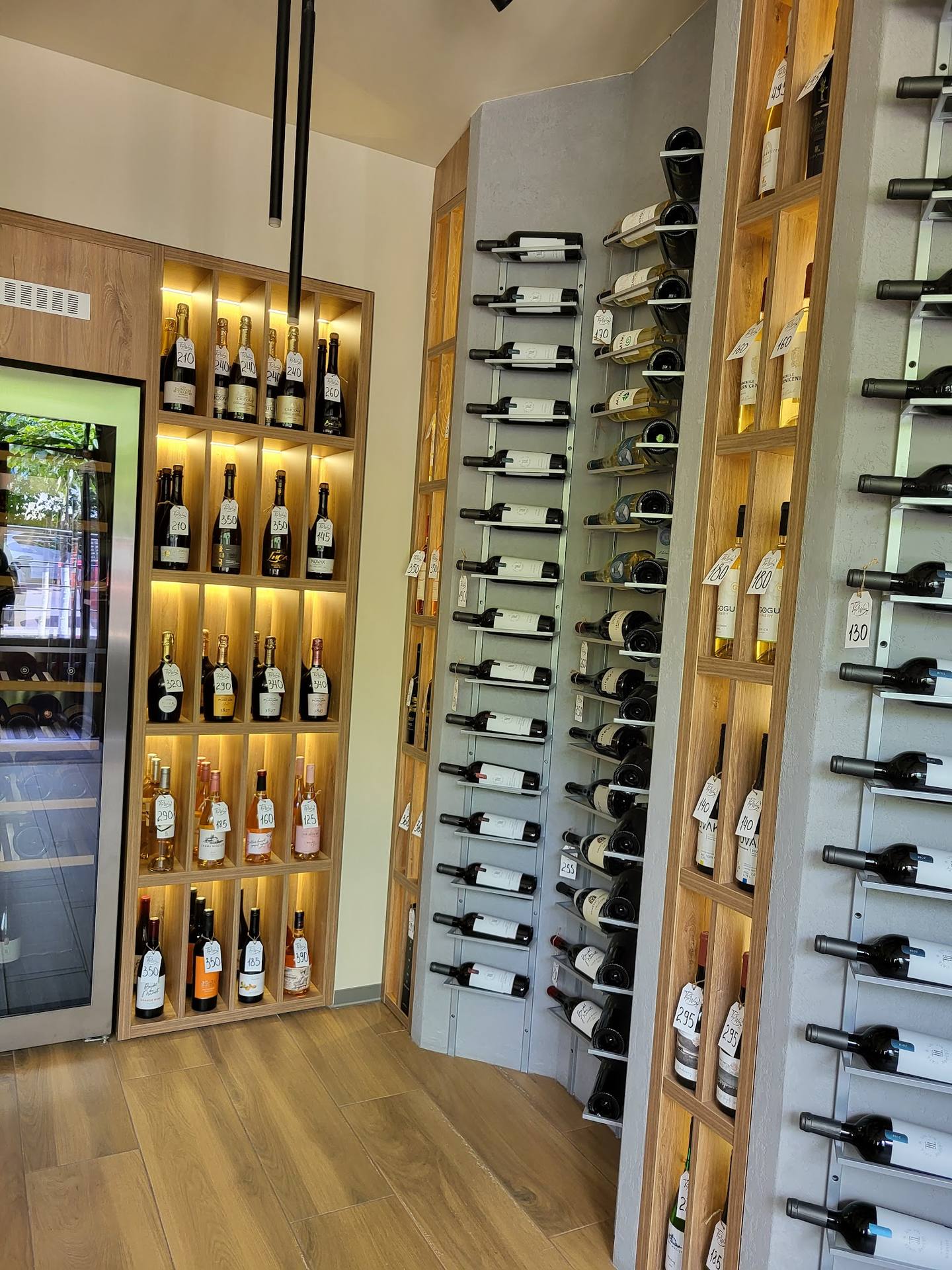Wine cellar interior with illuminated wooden wine racks and modern display shelving