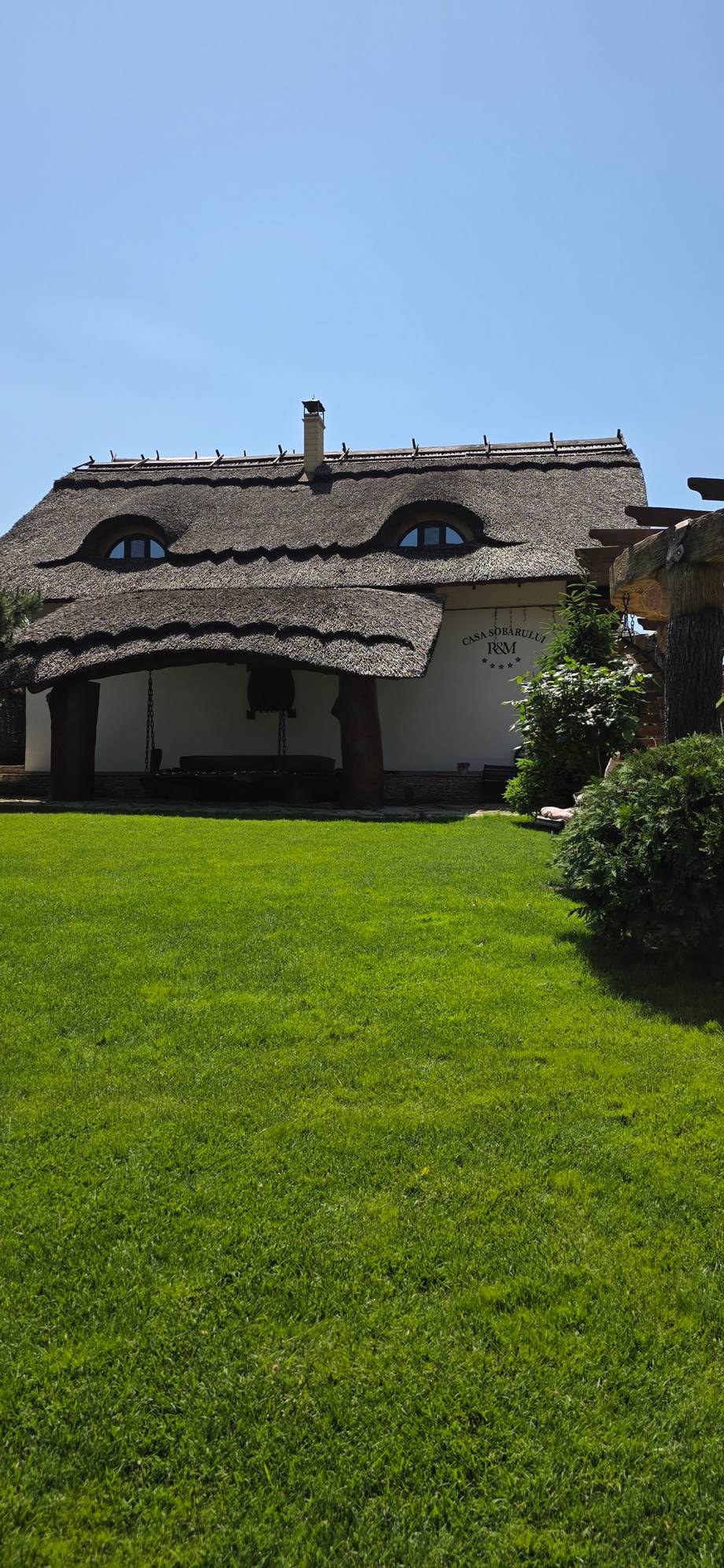 Historic thatched-roof cottage with distinctive architectural character and manicured grounds