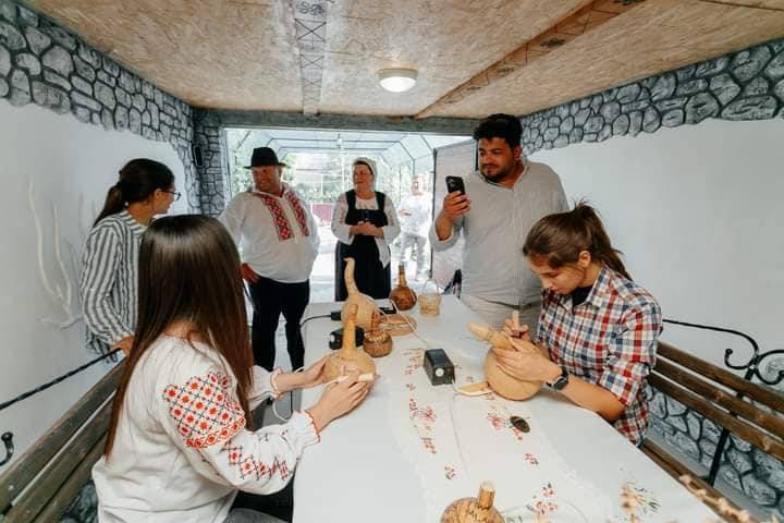 Group participates in hands-on craft or cooking activity in a workshop space