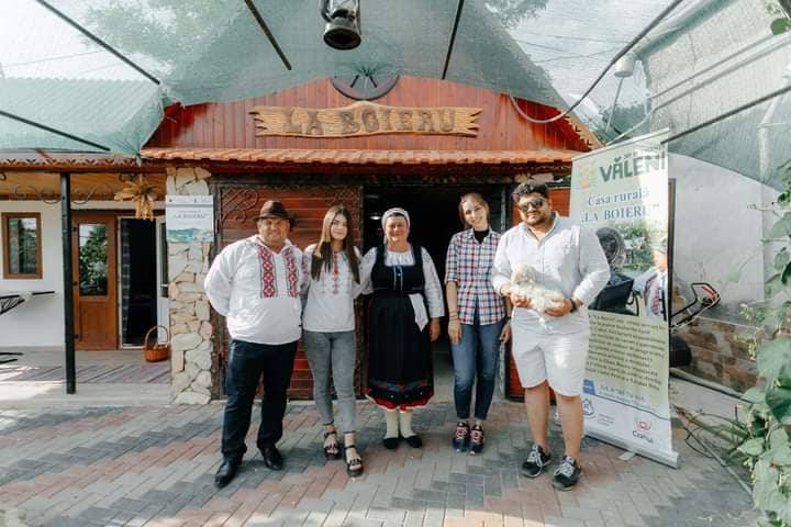 Group of staff members pose outside the storefront entrance with branded signage visible overhead