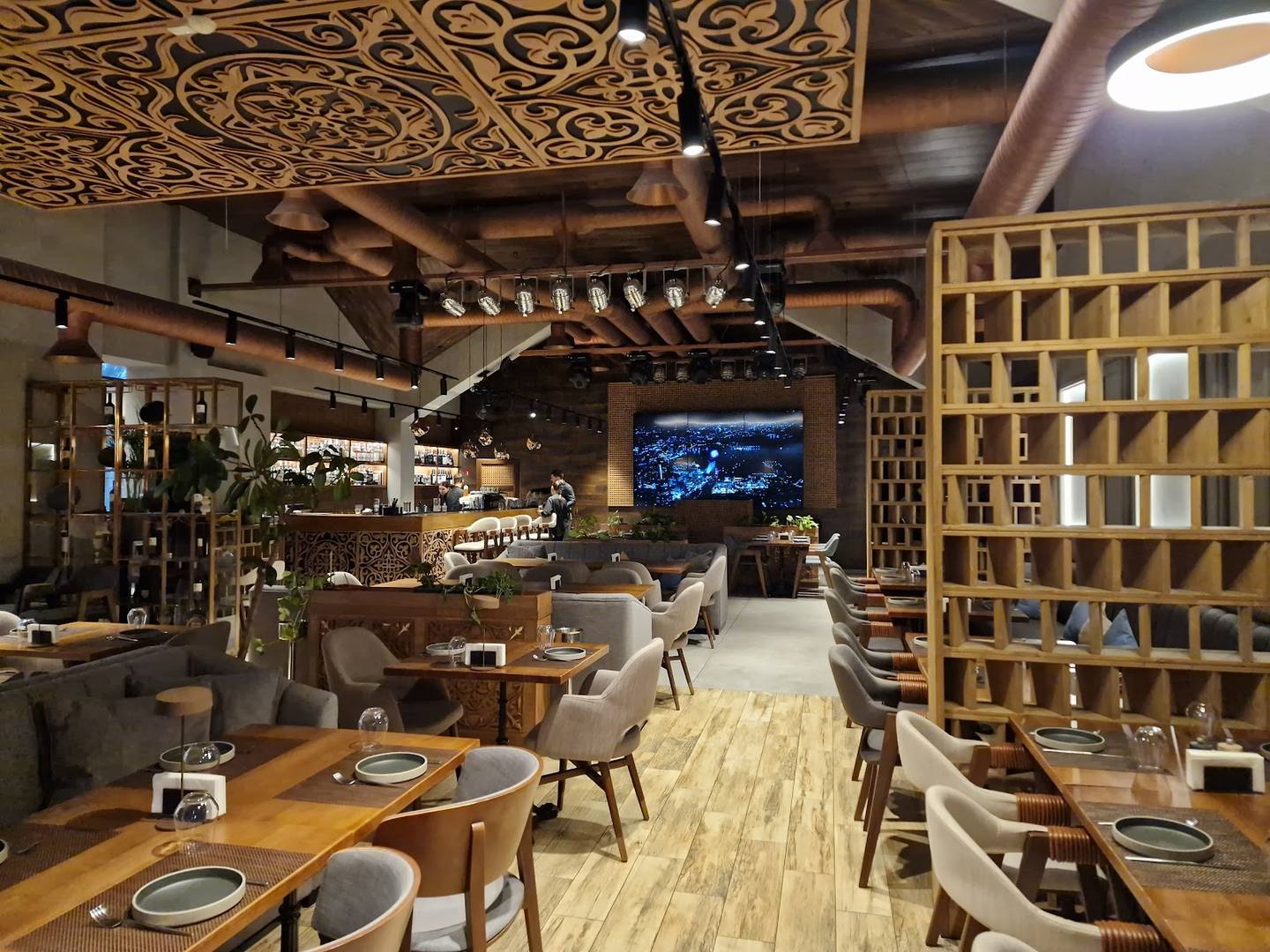 Modern upscale restaurant interior with warm wood accents and ambient lighting