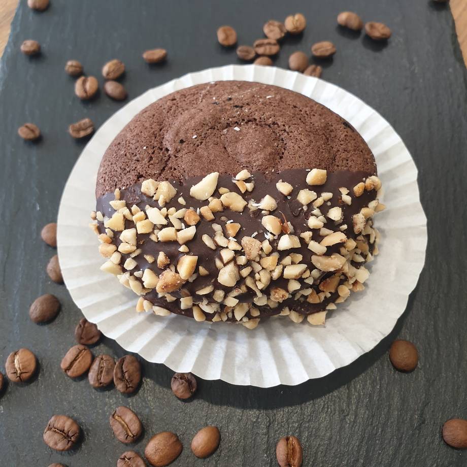 Chocolate hazelnut cake with nutty topping on dark slate surface