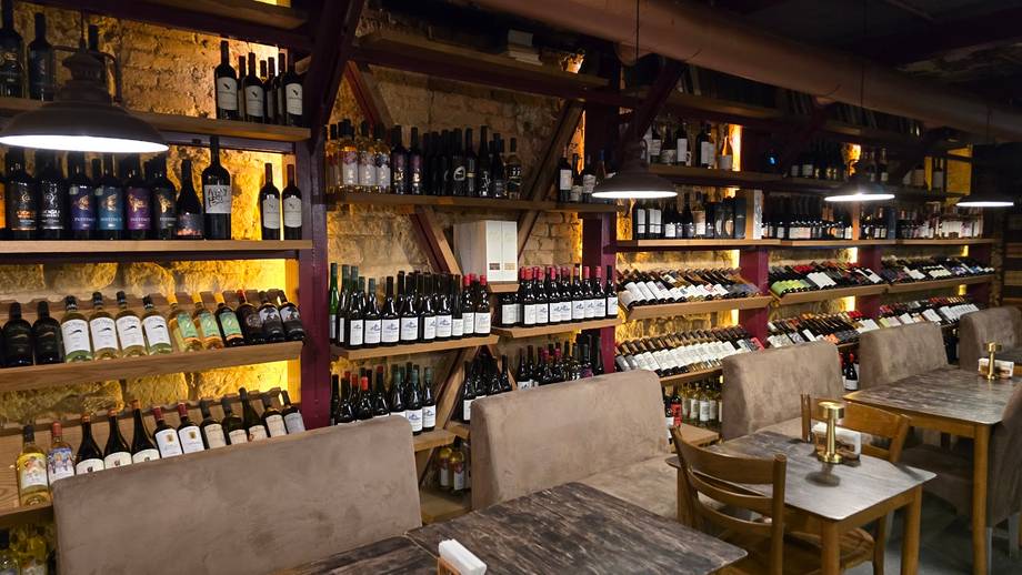 Wine shop interior with extensive bottled collection and ambient warm lighting