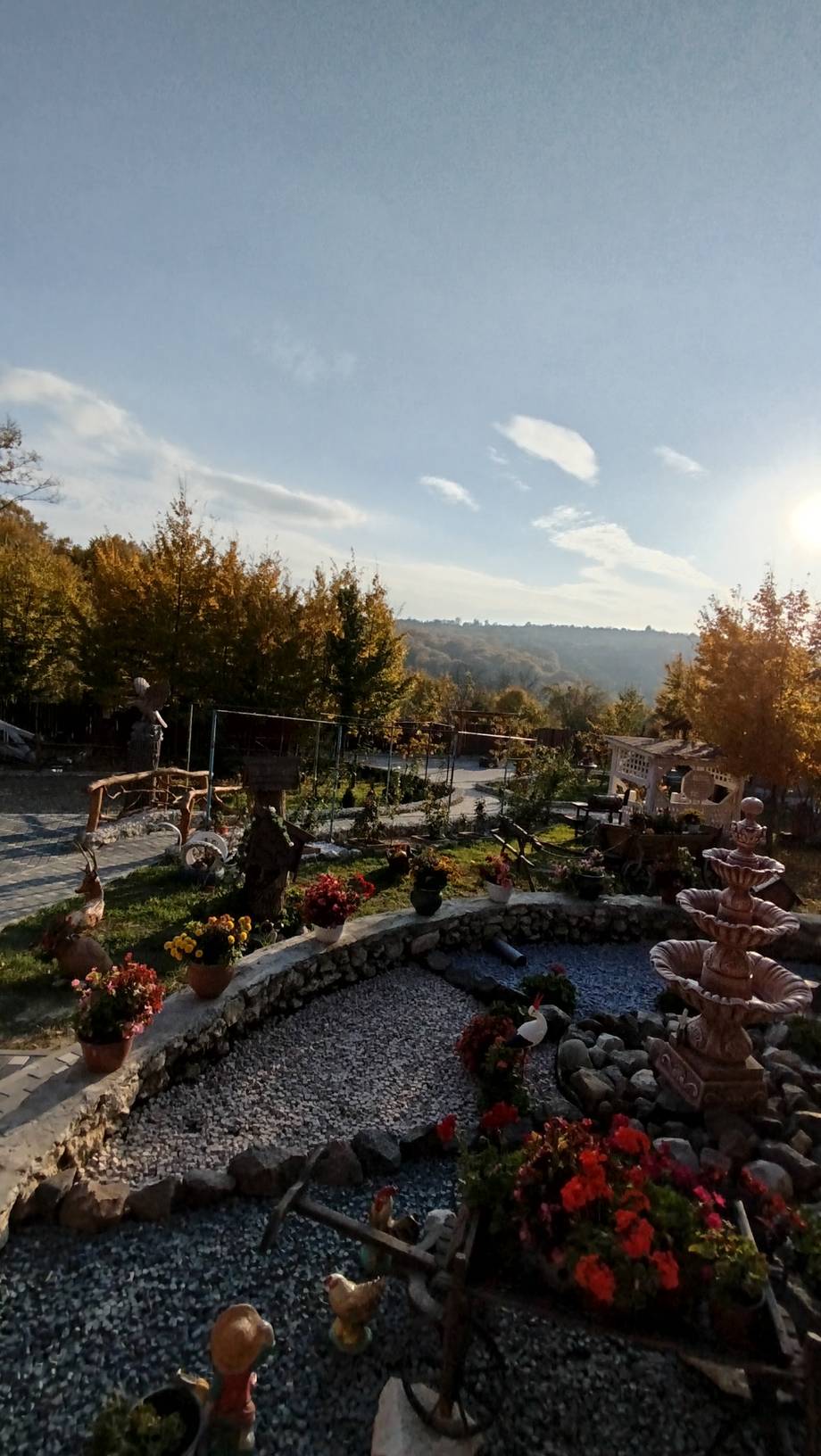 Elevated terrace garden with mountain valley views and autumn foliage