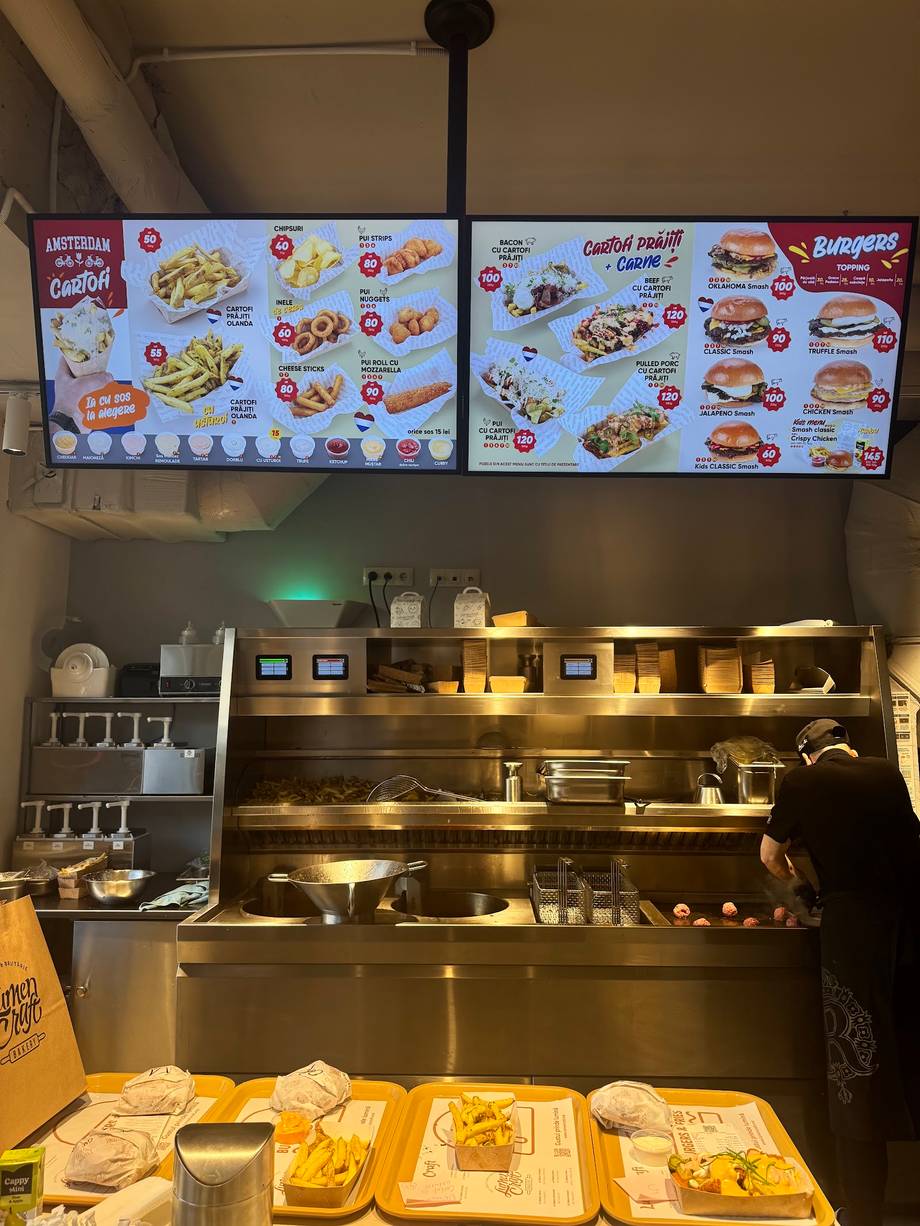Fast-casual counter service with menu boards and prepared food displays