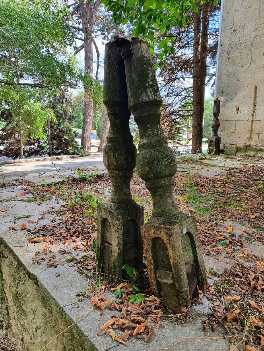 Weathered stone sculpture or artifact in outdoor courtyard setting