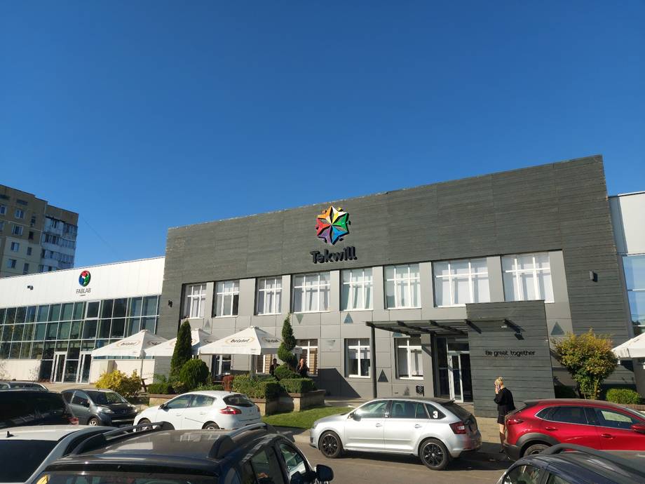 Modern sports/recreation center with colorful logo and ample parking lot