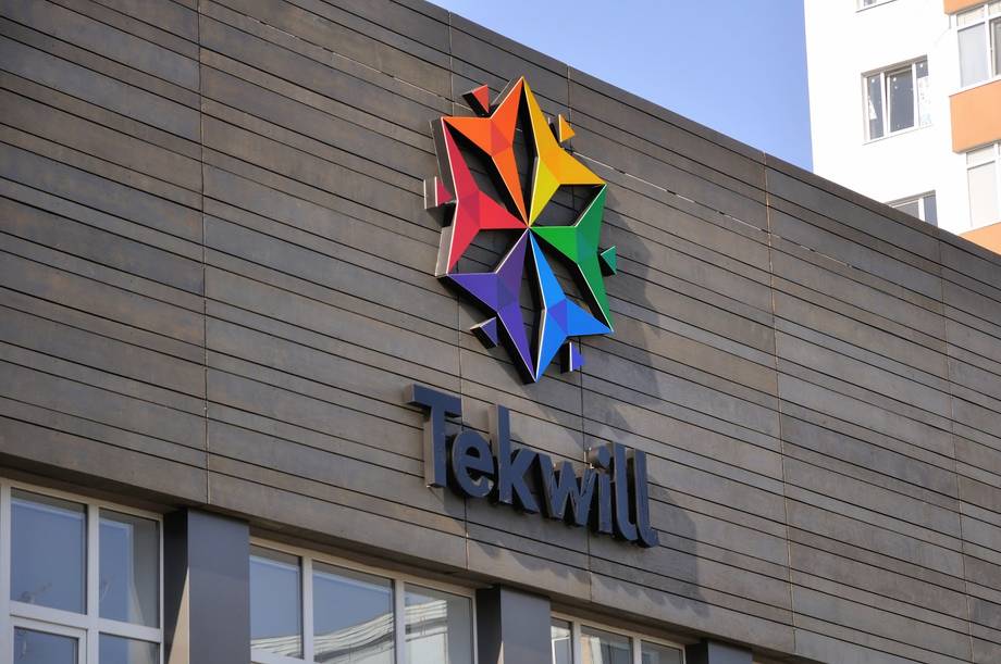 TeKwill storefront with colorful pinwheel logo and signage on modern facade