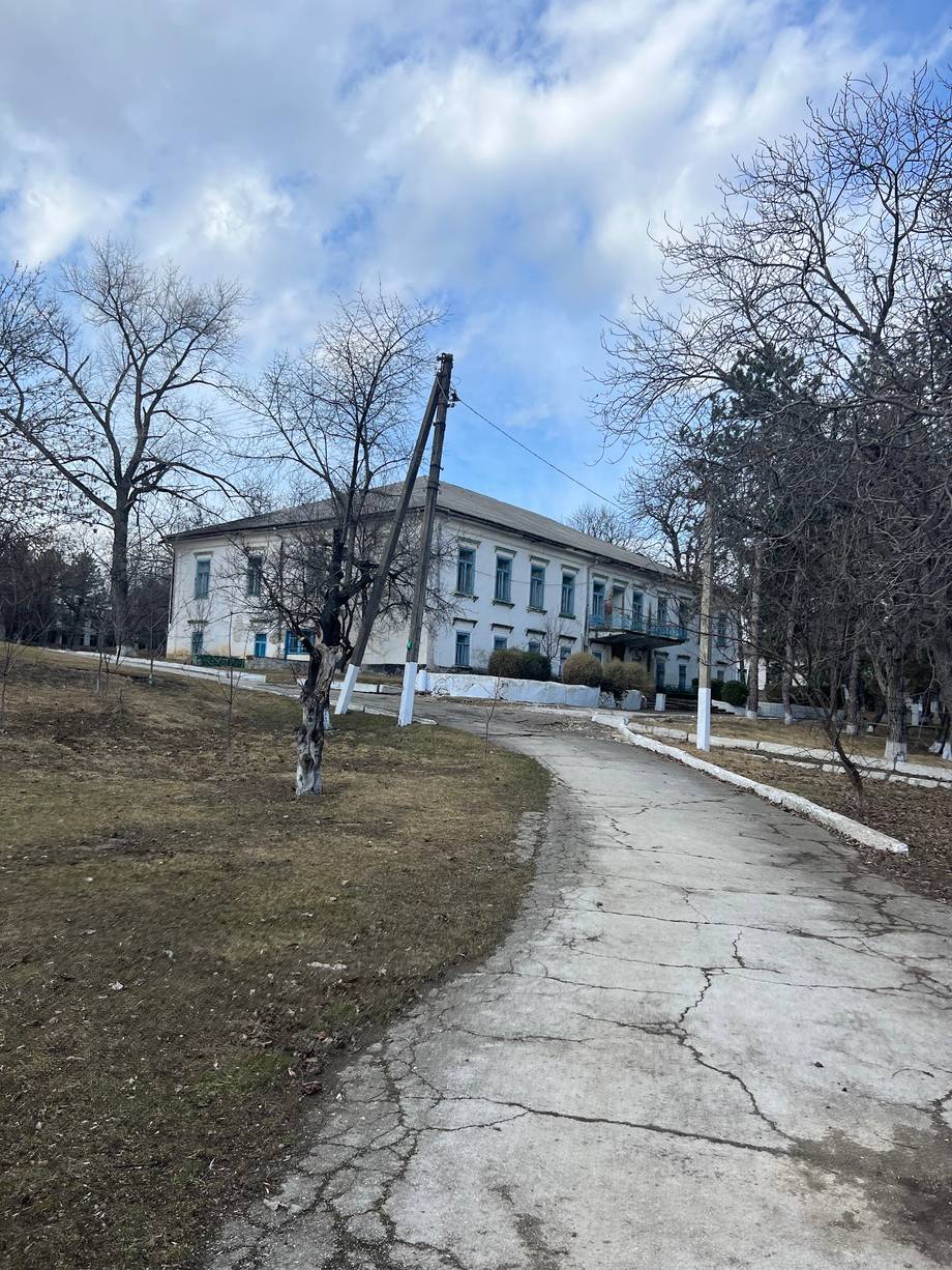 Neoclassical monastery building with white columns and clear front elevation approach