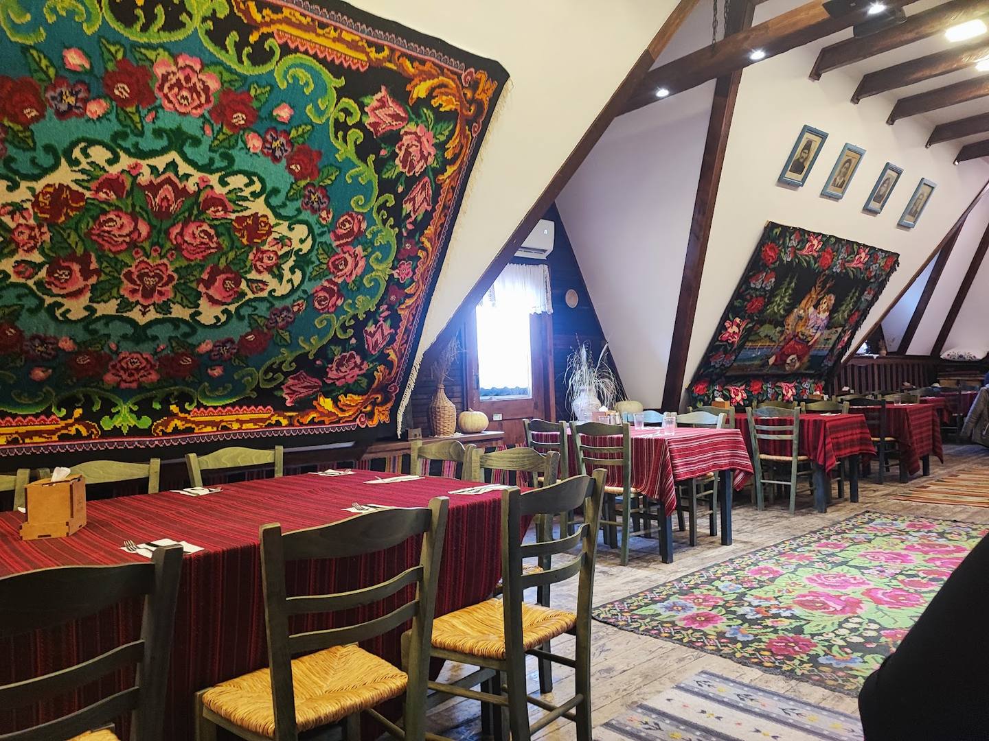 Traditional dining hall with ornate textile decorations and rustic wooden beams