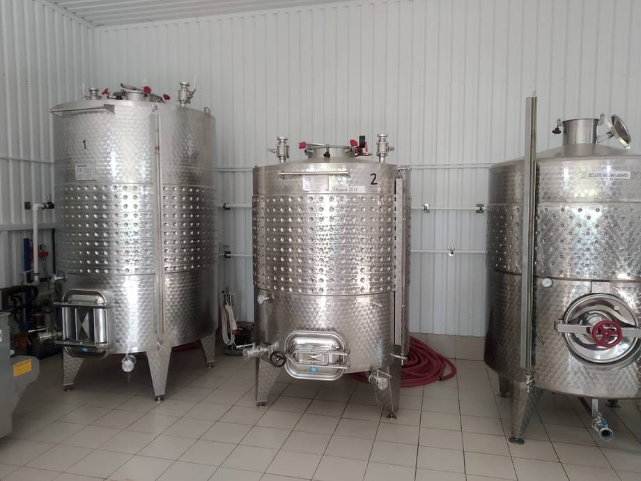 Stainless steel fermentation and storage tanks in modern winery production cellar