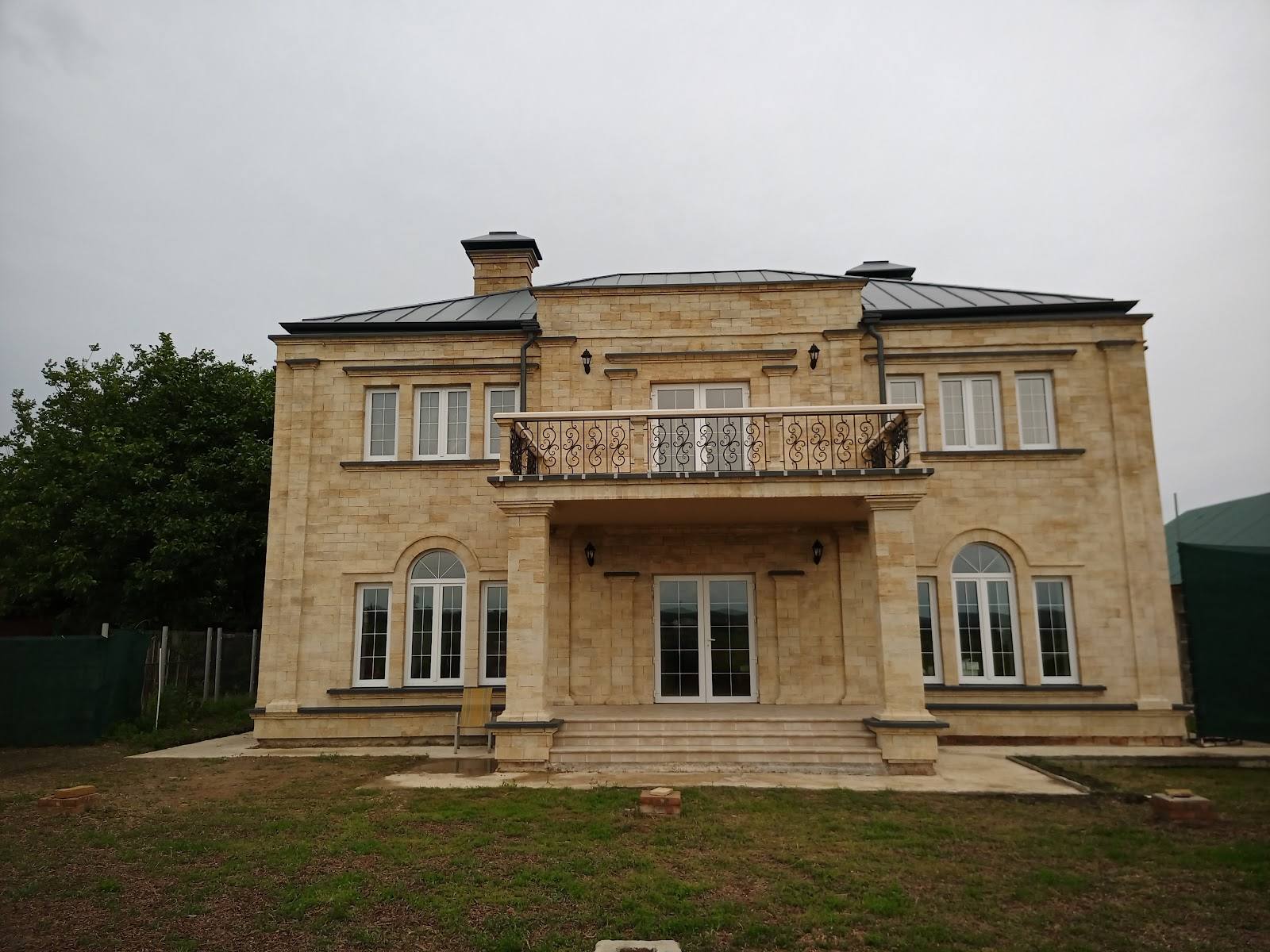 Classical stone villa with symmetrical facade and front terrace