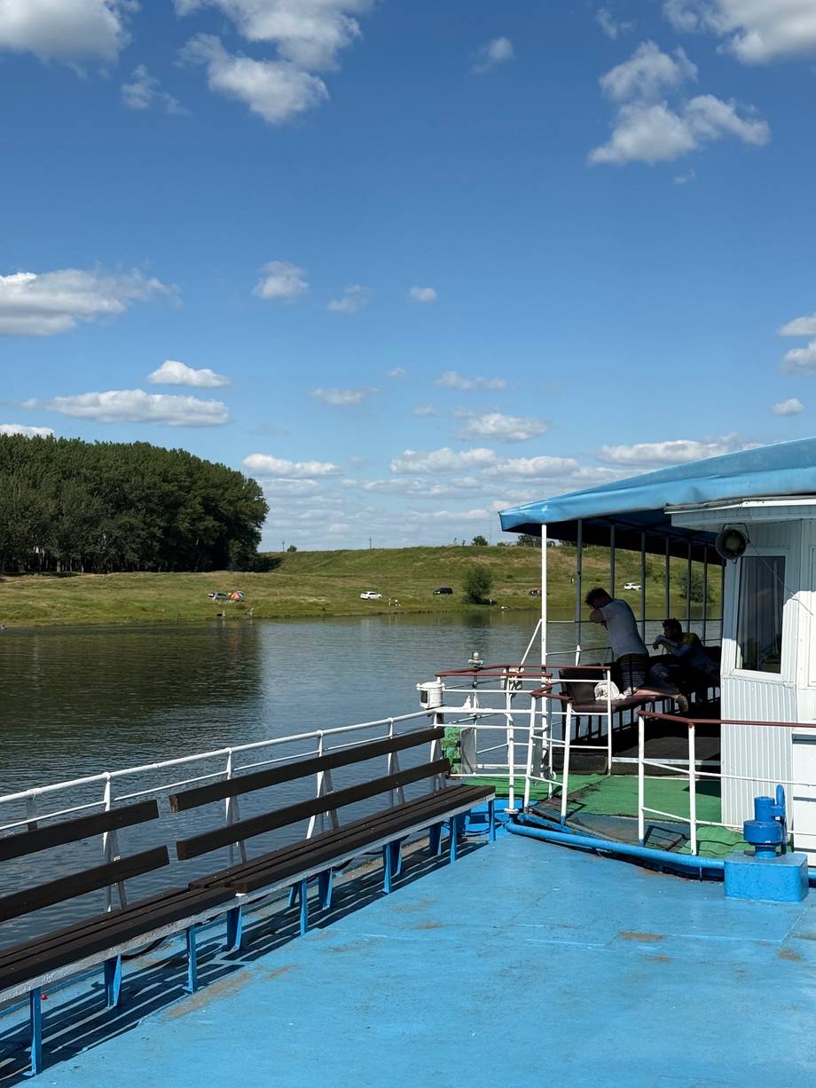 River boat deck overlooking wetland landscape with observation cabin