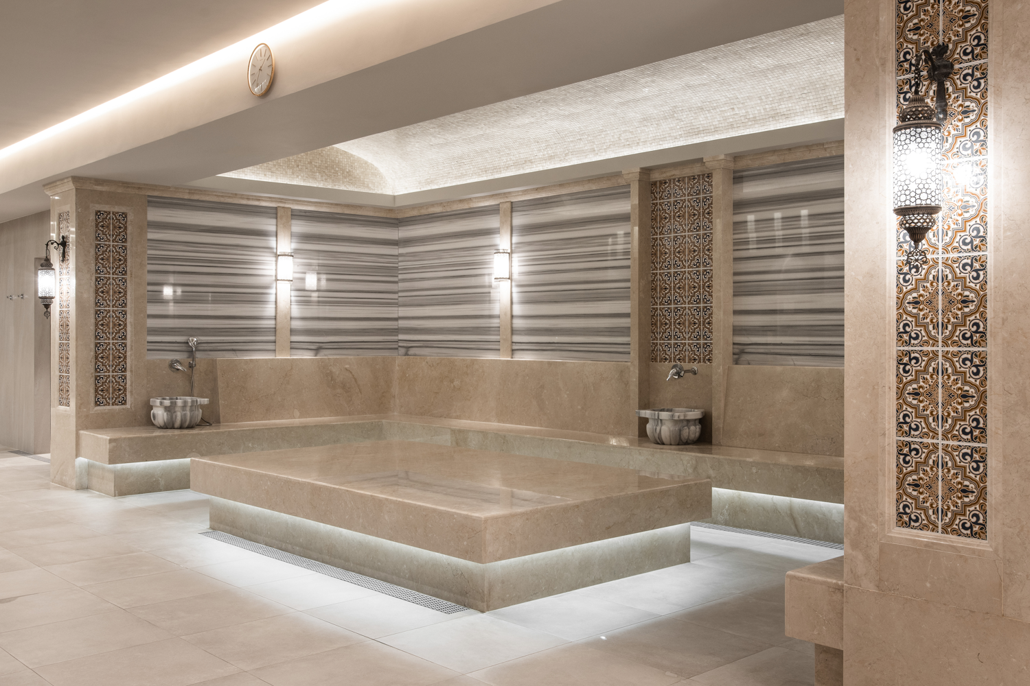 Modern spa hammam with heated stone bench and marble finishes