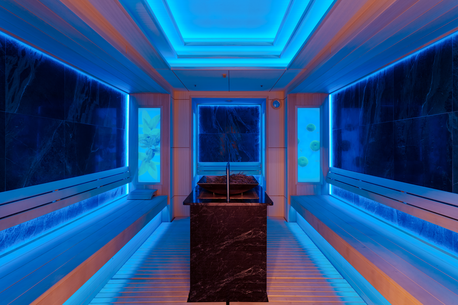 Neon-lit infrared sauna cabin with symmetrical blue and orange ambient lighting