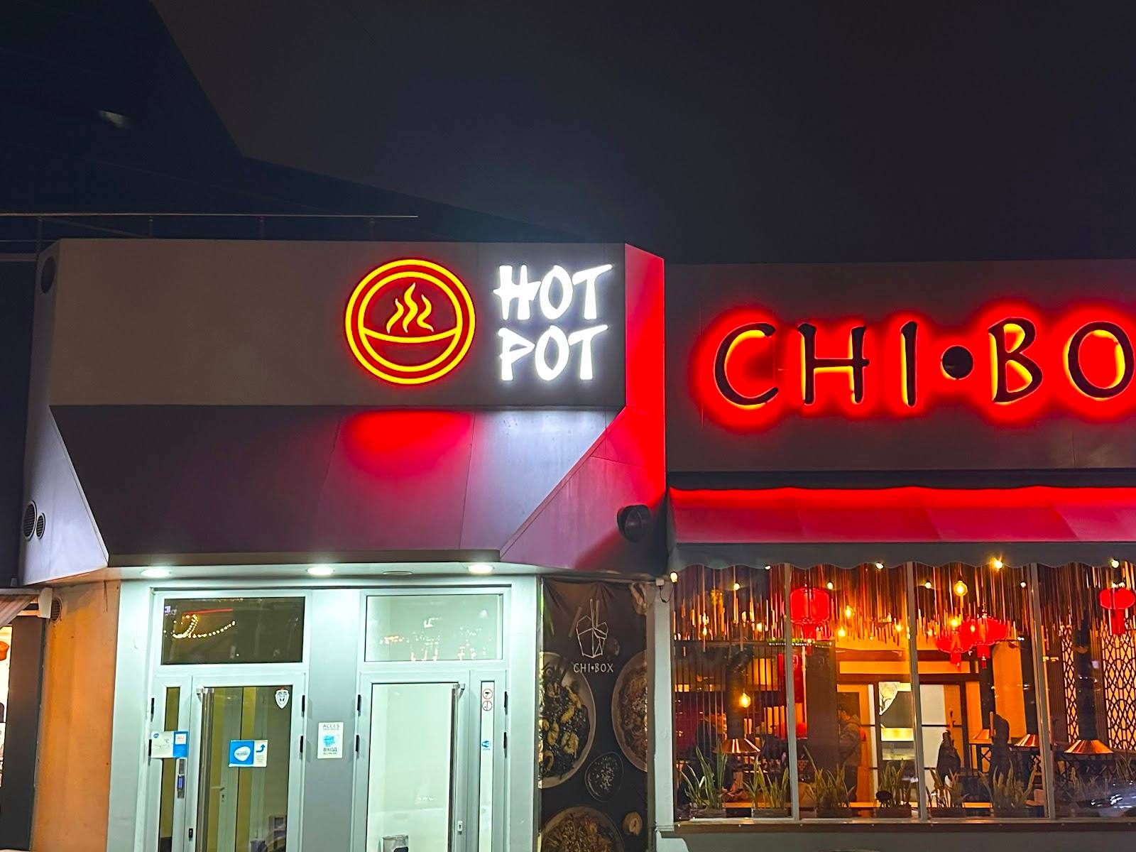 HOT POT and CHIBOQ neon storefronts at night with warm interior lighting