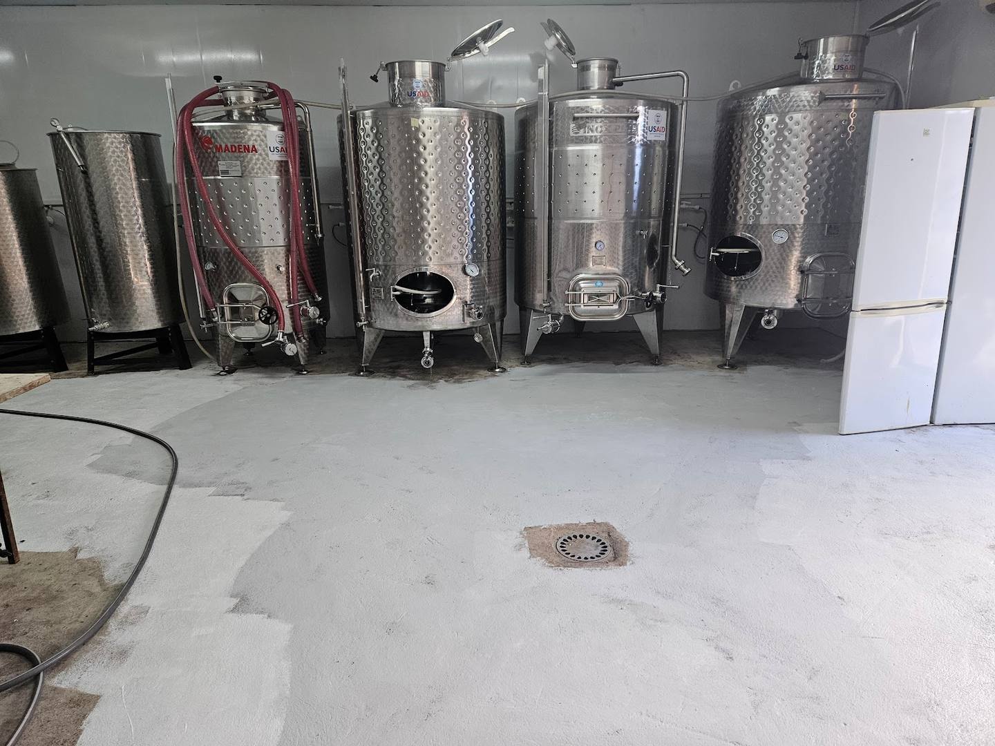 Stainless steel fermentation tanks in winery production cellar