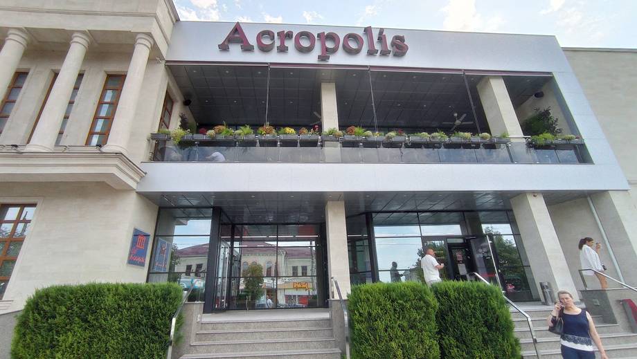 Aeropolis restaurant storefront with modern facade, signage, and terrace seating visible