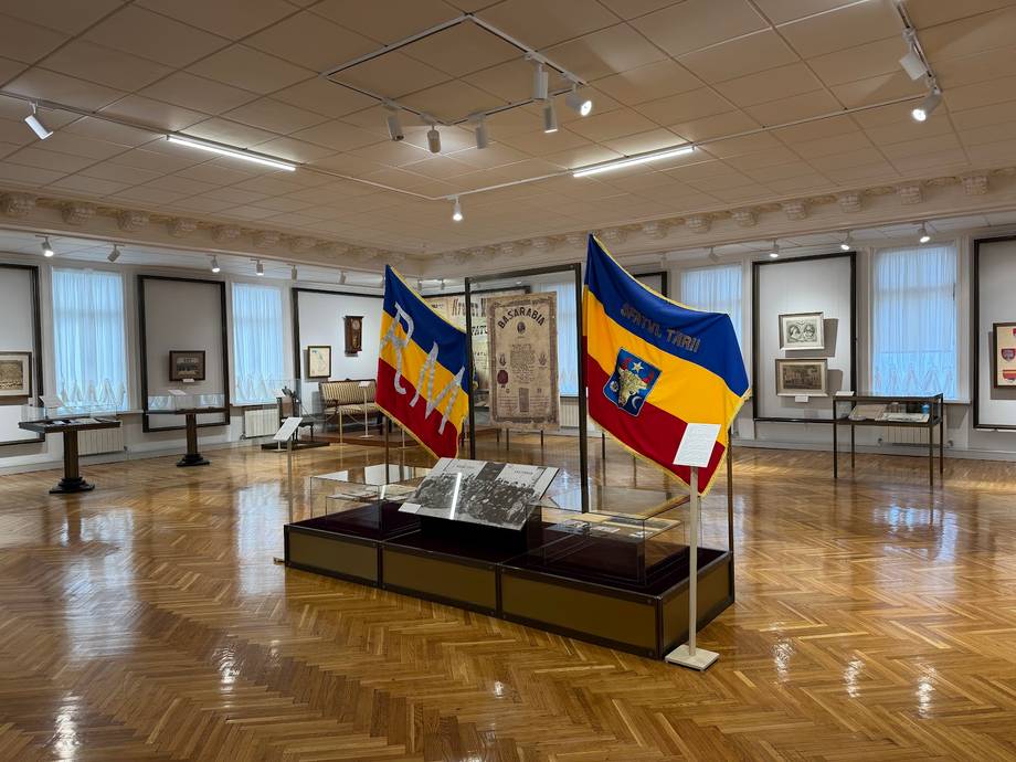 Historic monastery interior with heritage flags and artifact displays