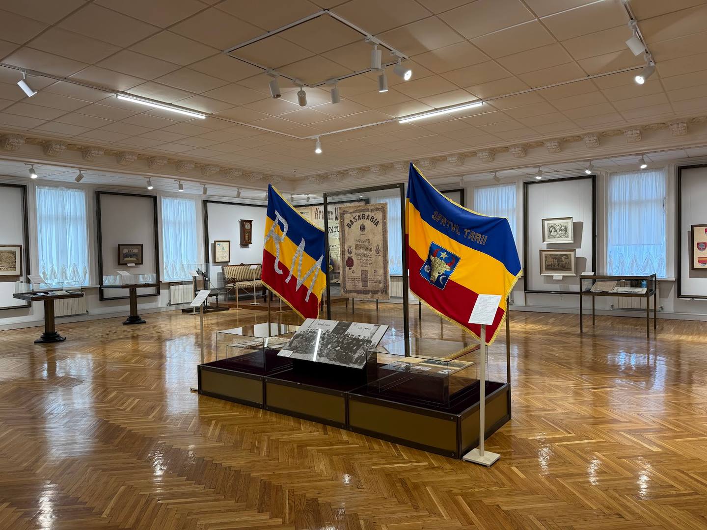 Historic monastery interior with heritage flags and artifact displays