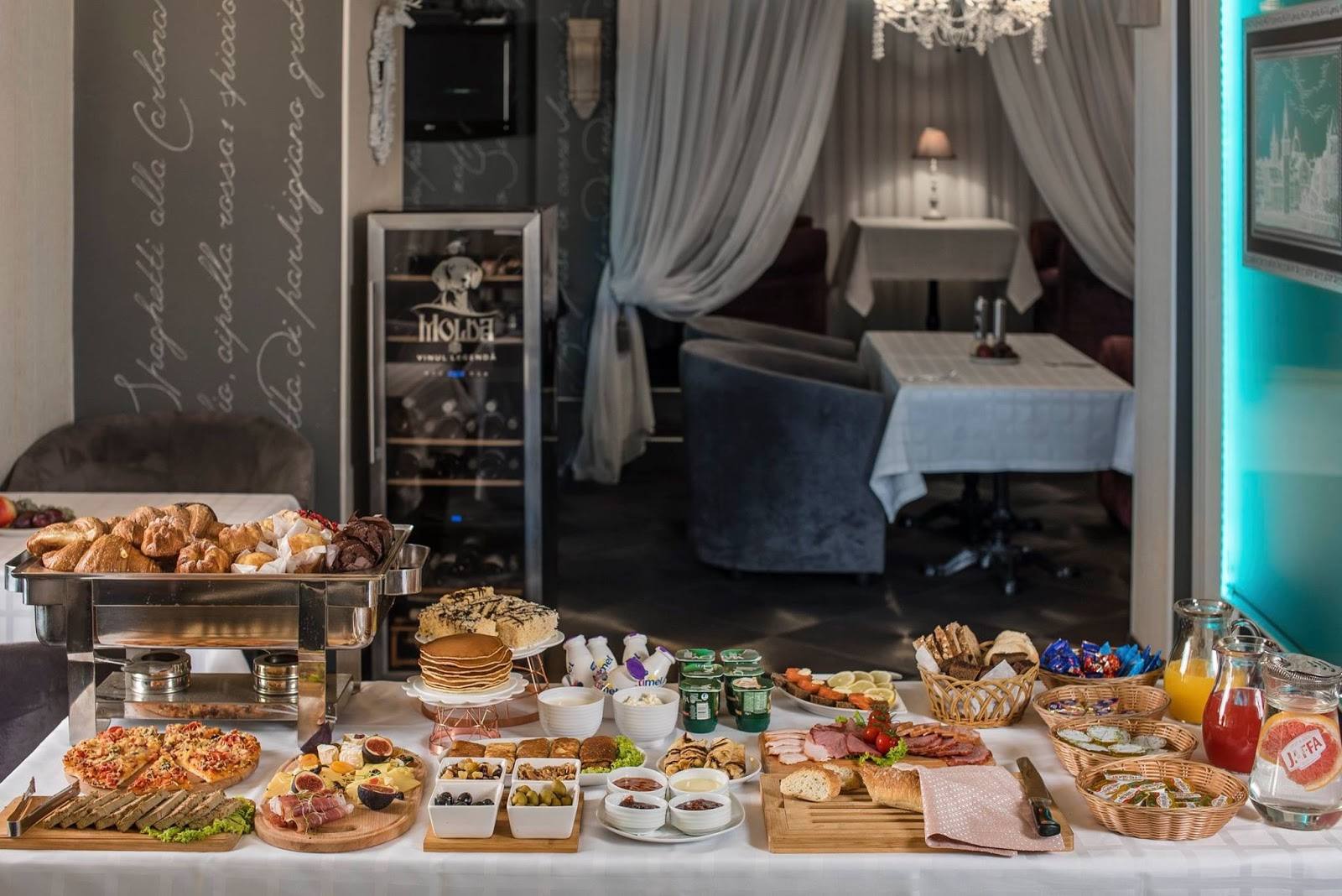 Brunch spread with pastries, breakfast items, and catering display in event space